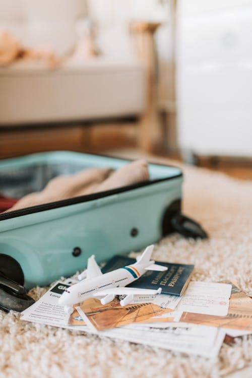 Travel essentials - suitcase, passport, and boarding passes