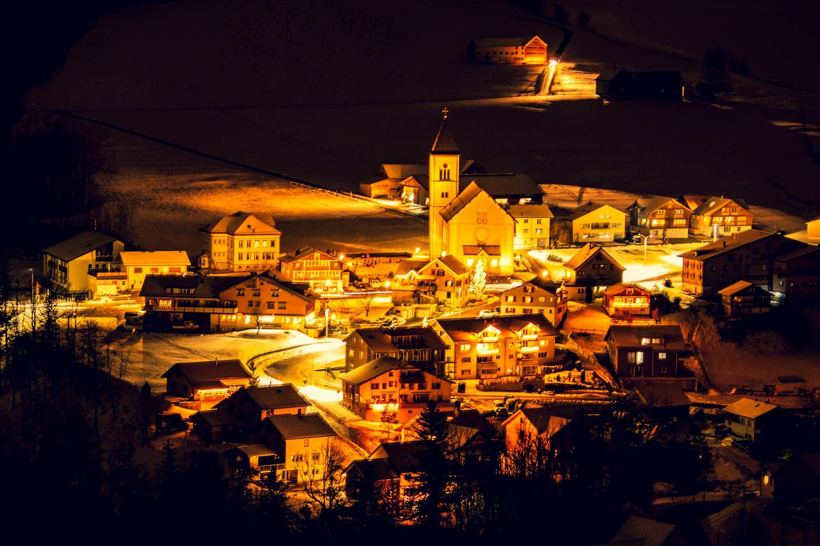 Snowy alpine village in Vail, Colorado at dusk during the holiday season